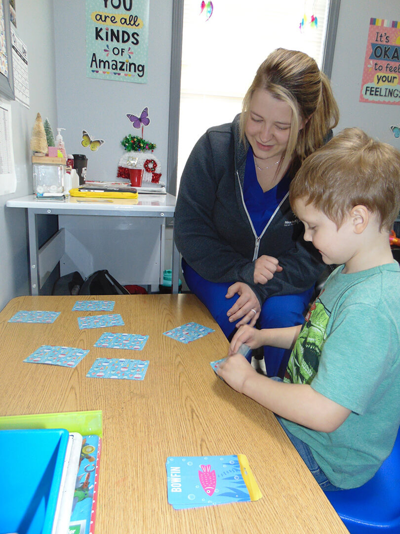 Staff with child doing Autism testing