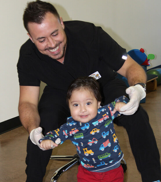 Therapist helping child walk