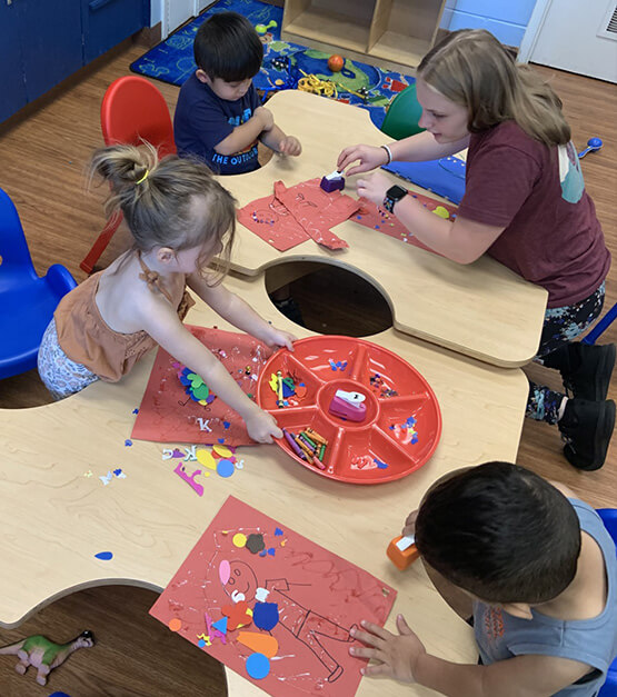 Kids drawing and painting in a classroom